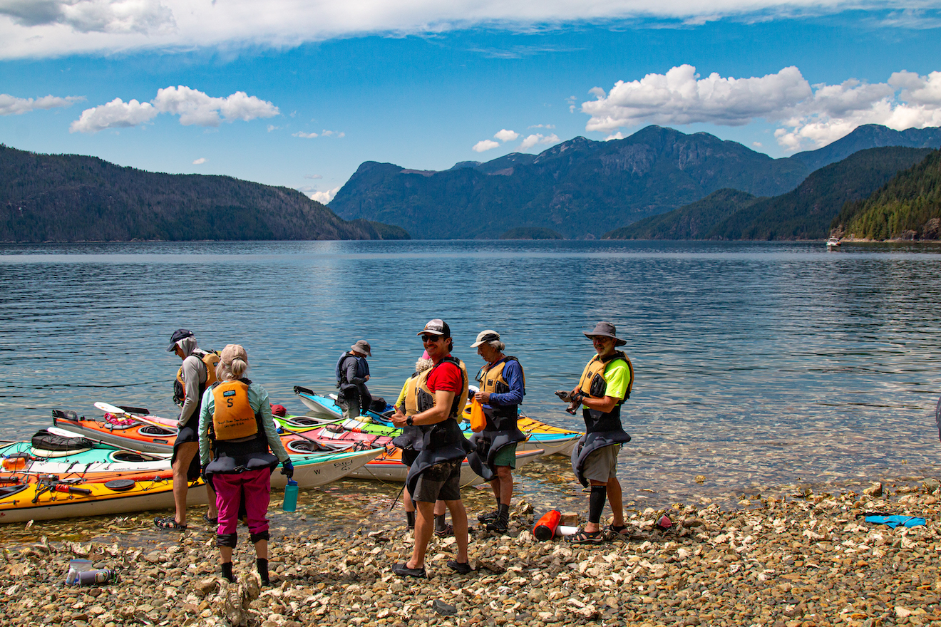 A group of kayakers taking a break on a kayak tour